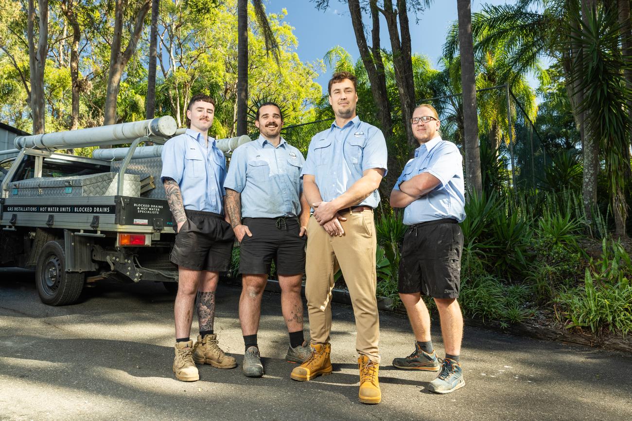 The Projection Plumbing team walking with their gear